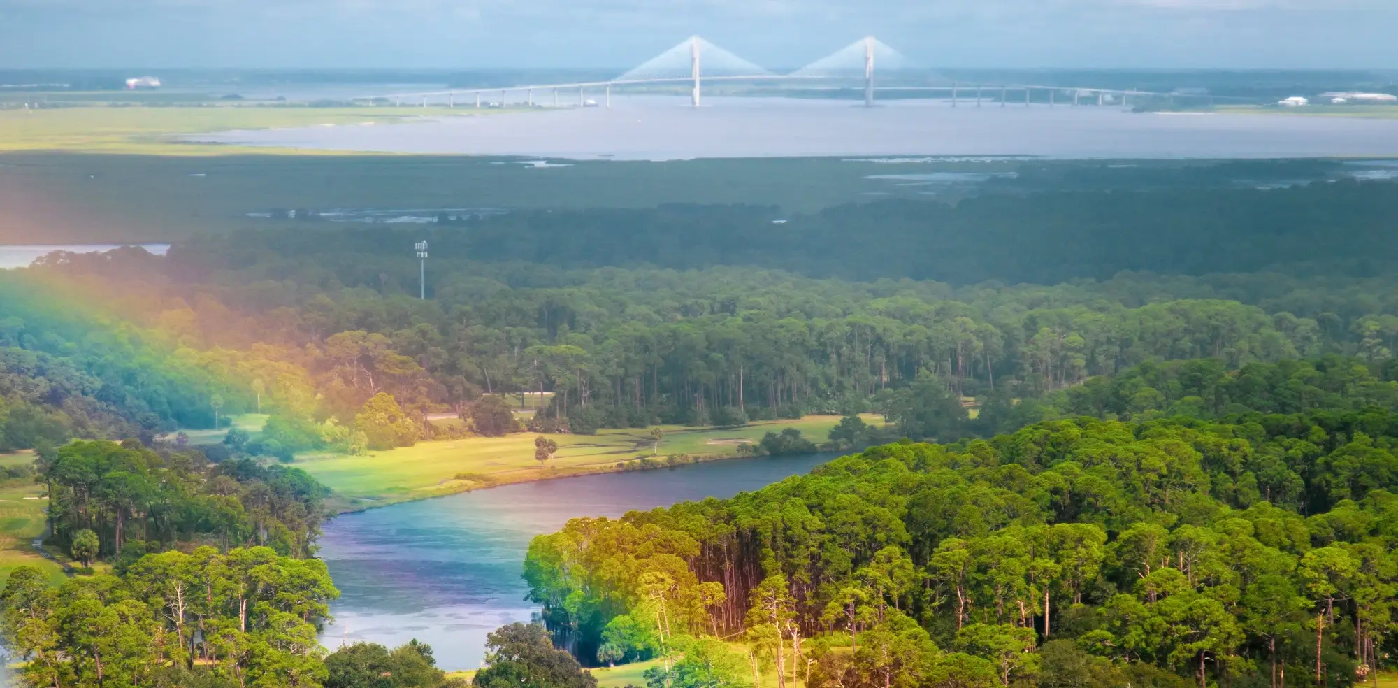 Aerial view of Sidney Lanier Bridge at St Simons Island with a rainbow in the background